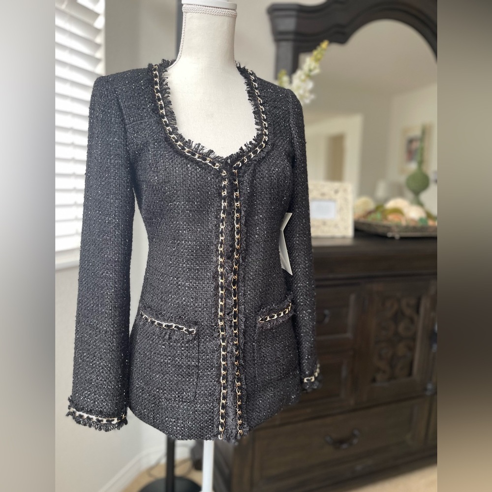 Fitted tweed black blazer with gold chain trim.